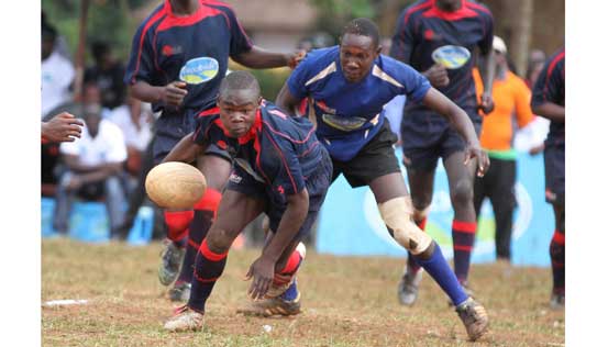 Upper Hills Rolf Smith Ouma of Nairobi (with ball) is tackled by Mwata Mwakari of Menengai School 